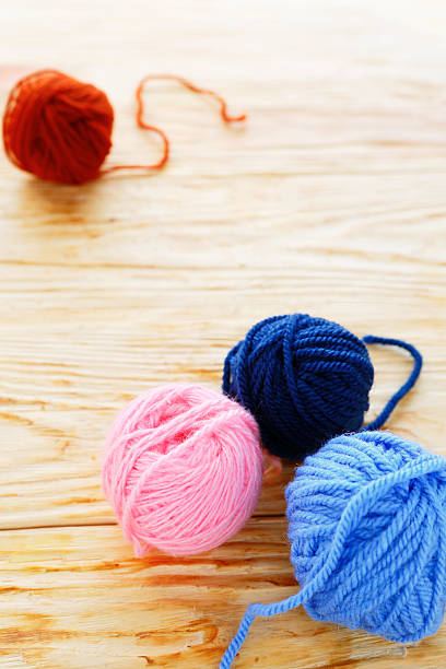 istock wooden background with balls of wool 501996657