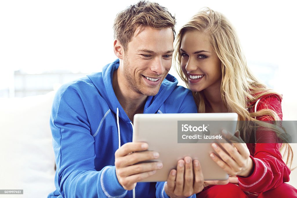 Young couple using a digital tablet Close up of young couple using a digital tablet together.  20-24 Years Stock Photo