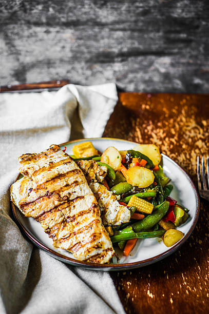 istock Grilled chicken with baked vegetables on rustic background 501998985