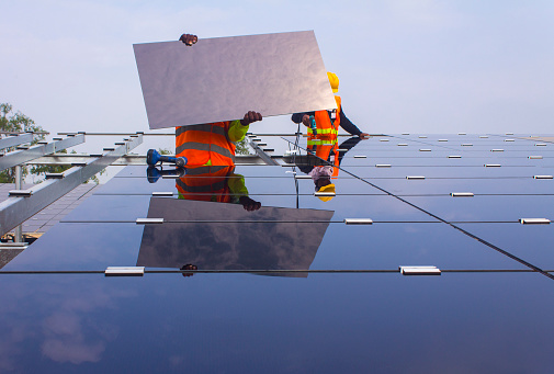 Bangkok, Thailand - October 22, 2015: Men installing solar panels at a solar farm