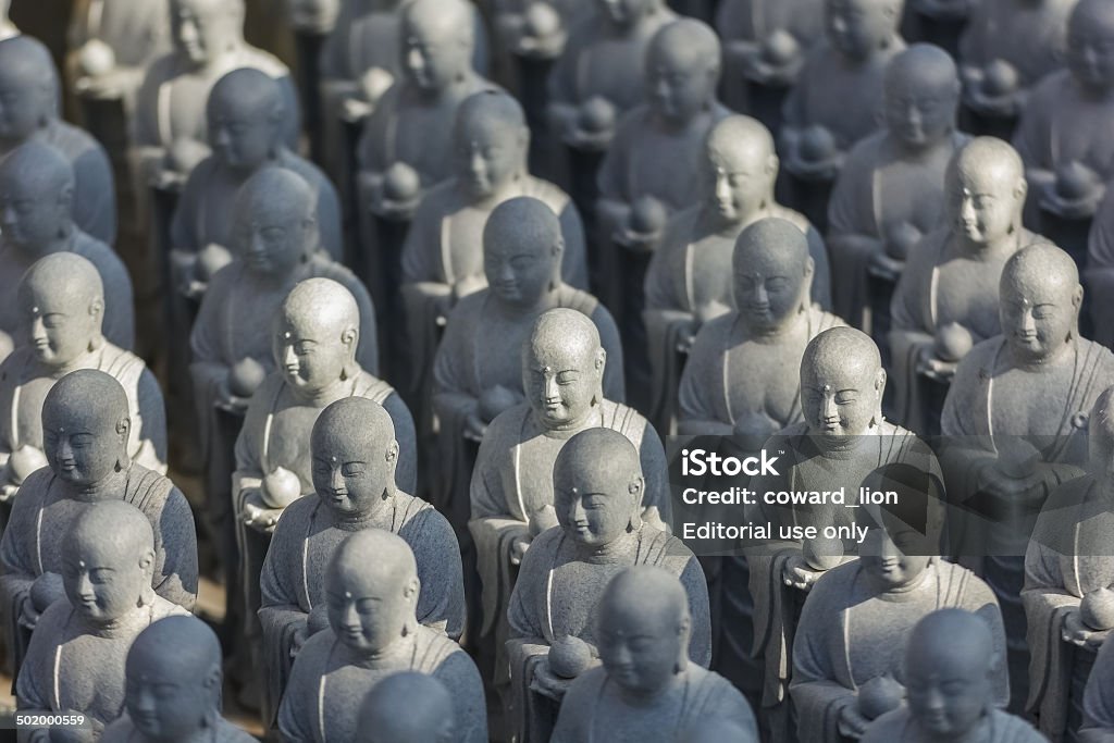 Small Jizo Statues at Hase-dera Temple in kama Kura Kamakura, Japan - November 24 2013: At Hase-dera temple, parents came to set up the statues in hopes the deity would protect their children Architecture Stock Photo