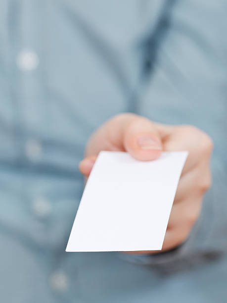 istock front view of blank business card in fingers 502000863