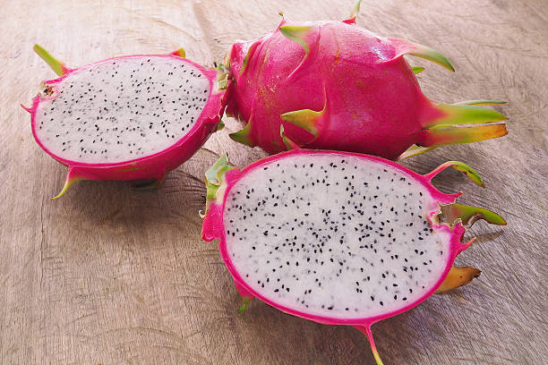 istock Dragon Fruit and some slice on old Wooden Table 502000938