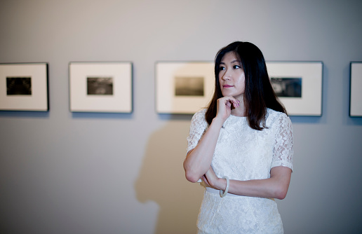 young  woman standing in an art gallery