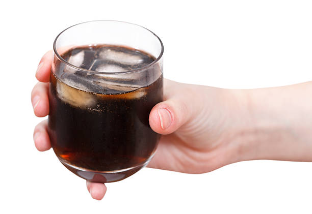 istock hand holding cola with ice in glass 502001411