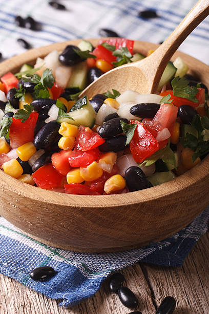 istock salad with black beans, avocado, corn and tomatoes closeup verti 502002132