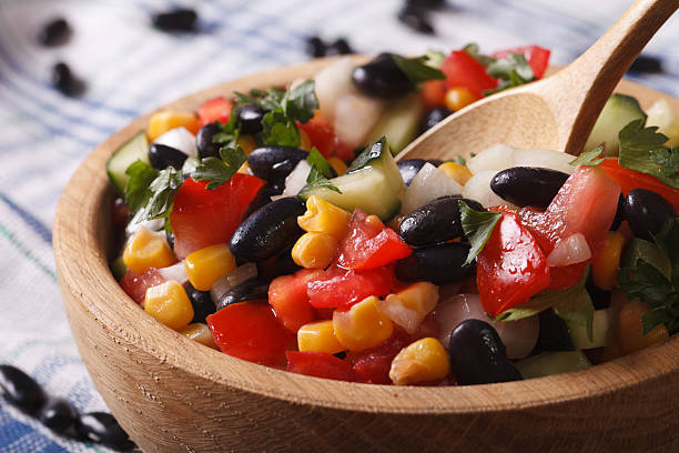 istock Mexican salad with black beans, avocado, corn and tomatoes macro 502002244