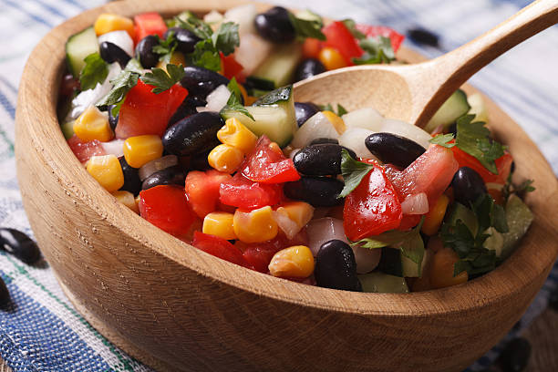 istock Mexican vegetable salad macro in a wooden plate. horizontal 502002360