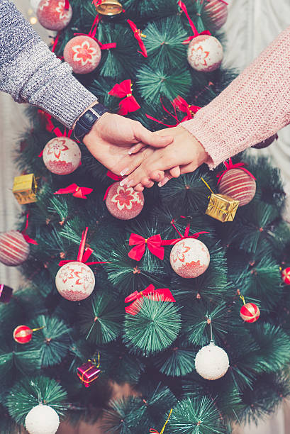 istock Couple holding hands in front of a Christmas tree 502002846
