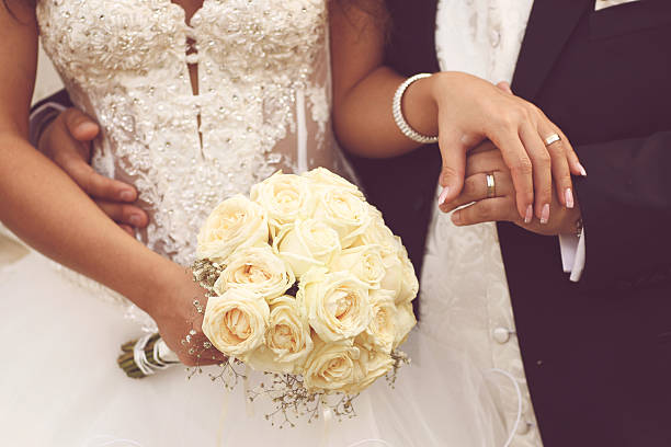 Detail of bride's roses bouquet and hands holding Detail of bride's roses bouquet and hands holding lovely day bridegroom stock pictures, royalty-free photos & images