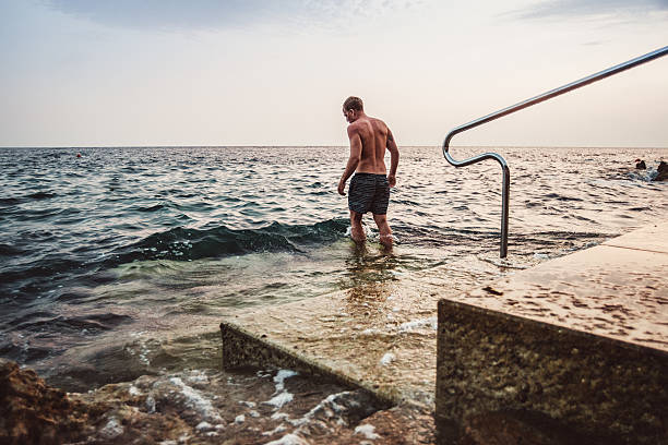 mature adult man swimming in the sea