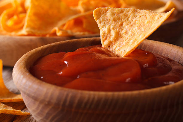 istock Tomato sauce and corn chips nachos macro. horizontal 502005020
