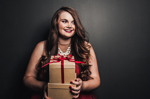 Happy woman holding christmas gifts