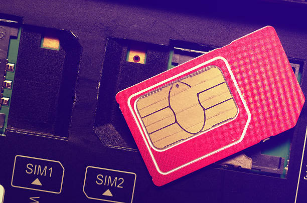 istock Red SIM card on slots in mobile phone. 502007038