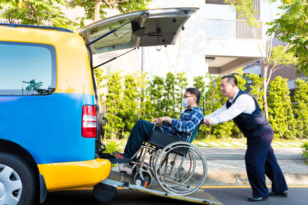 istock driver helping man on wheelchair getting into taxi 502009832