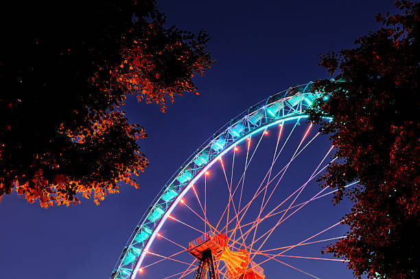 istock Part of ferris wheel with orange and light blue illumination 502012306