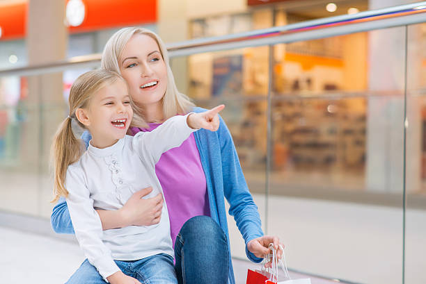 istock Mother and daughter shopping in mall 502012640