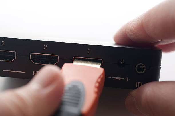 istock Hand holding hdmi cable to plug in of device 502018151