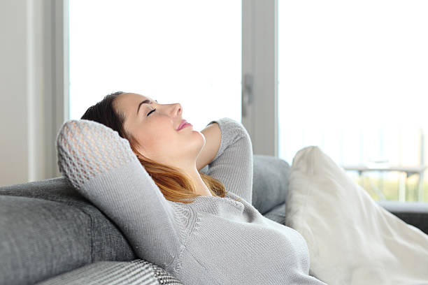 istock Happy relaxed woman resting on a couch at home 502019245