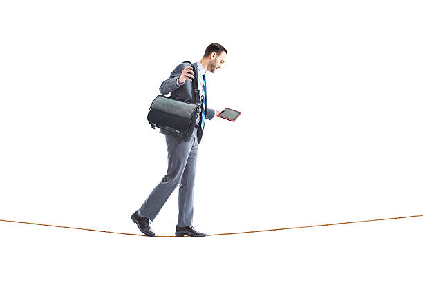 istock Businessman Walking Tightrope on White Background 502021883