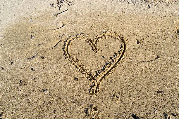 heart symbol drawn in the sand