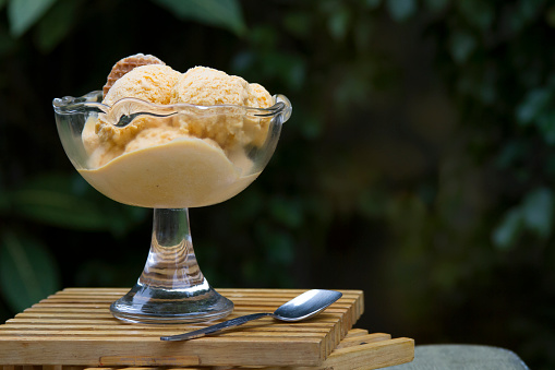 Lucuma Ice Cream from Peru with a caramel cookie outdoors