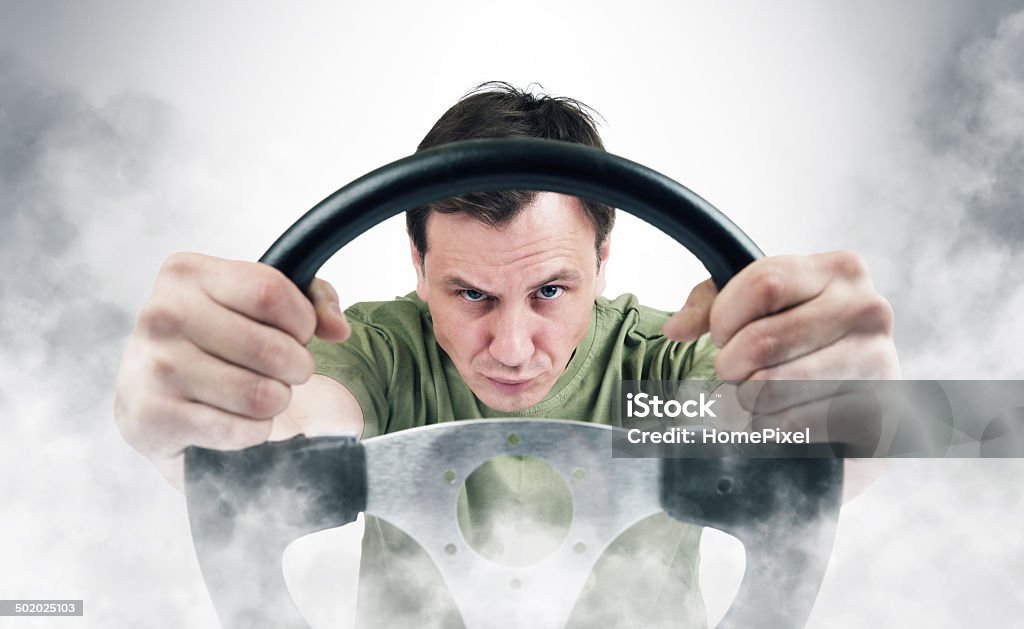 Funny man with a steering wheel in smoke Humor Stock Photo