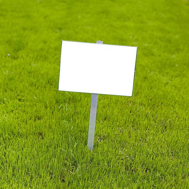 Sign on grass stock photo