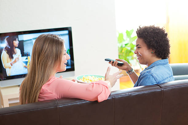 istock Two young women talk and watch TV 502025393
