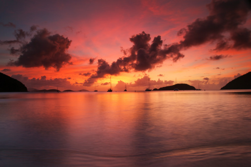 sailboats at anchored during beautiful sunset at Maho Bay Beach, St.John, US Virgin Islands