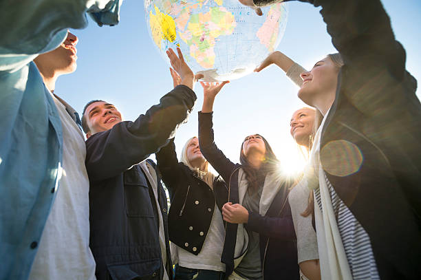 istock Group of people holding a world globe 502034667