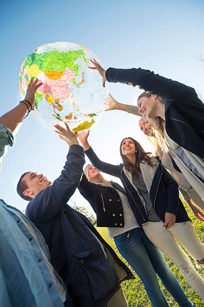 istock Group of people holding a world globe 502034675