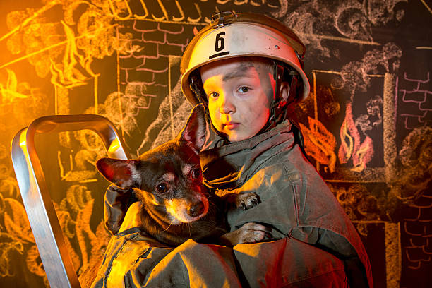 istock Little firefighter rescuing dog 502035353