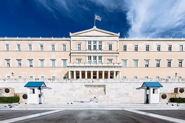 The greek Hellenic Parliament Building under blue summer sky. Athens, Greece.