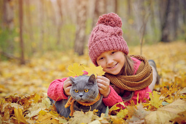 istock Child and cat in autumn 502036347
