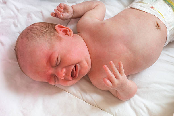 Baby or newborn is crying and suffers from colic Baby or newborn is crying and suffers from colic ugly people crying stock pictures, royalty-free photos & images