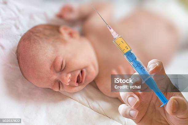 Doctor Holds Syringe To Vaccinate Sick Baby With Injection Stock Photo - Download Image Now