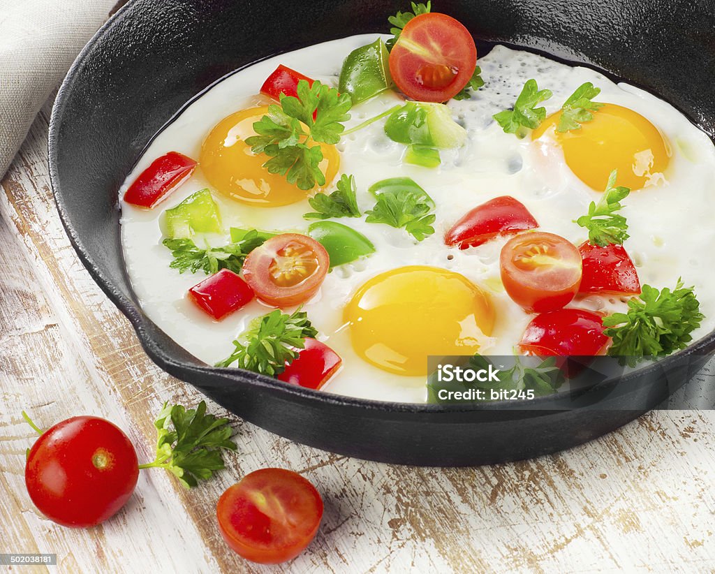 Fried eggs Fried eggs in a pan with vegetables. Selective focus Breakfast Stock Photo