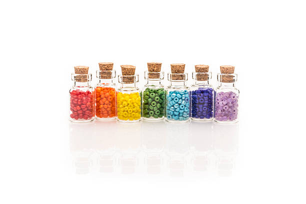 Tiny glass bottles filled with colourful rainbow of beads