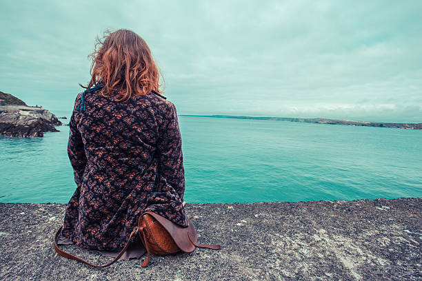 istock Young woman by the water's edge 502039613