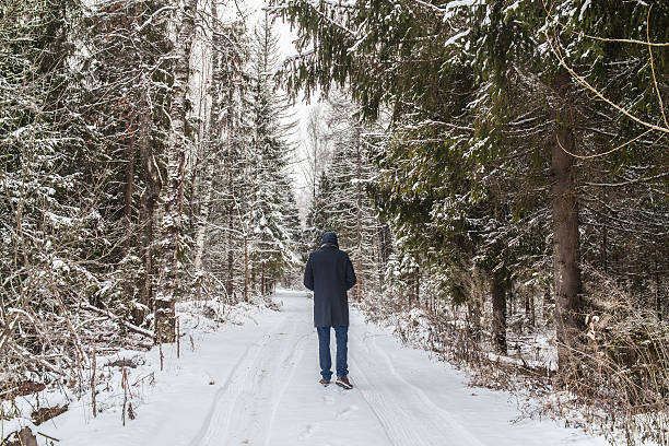 istock People standing in a winter forest 502040024