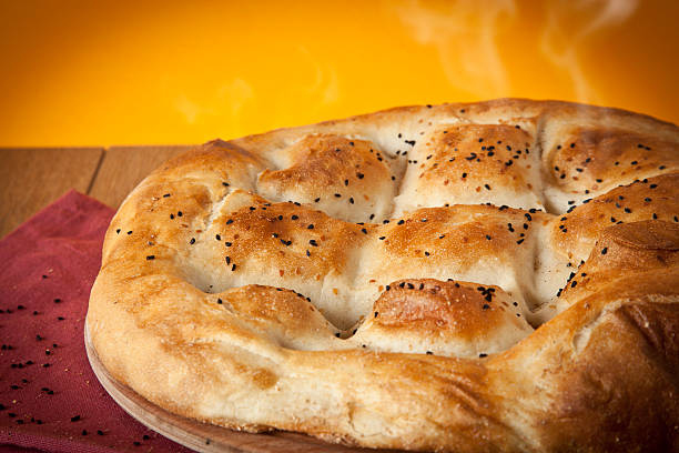 istock Turkish Ramadan Bread, Ramazan Pidesi wooden table with yellow background 502041353