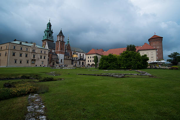 Krakow, Poland - June 28, 2015: Tourists near the Wawel cathedral. Originally built in the XIV century, the cathedral is a most important burial place of Polish kings and national heroes