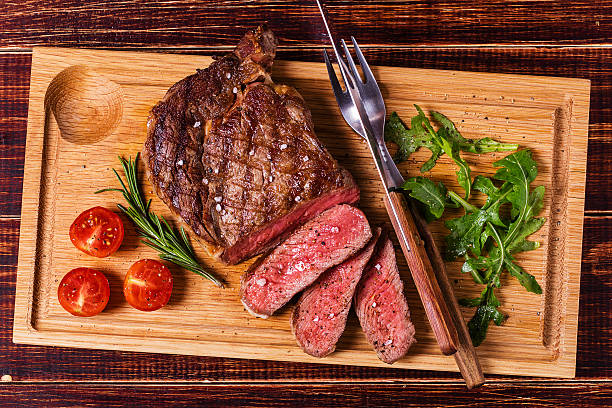 istock Ribeye steak with arugula and tomatoes. 502045066