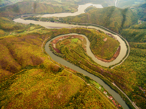 Aerial photograph of a meandering West Morava river with a settlement and a church, in Ovcar Kablar gorge. West Serbia.