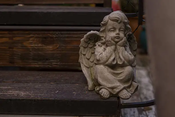 Photo of Angel figure sitting on bench