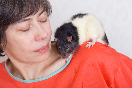 The woman with a black-and-white rat on her shoulder