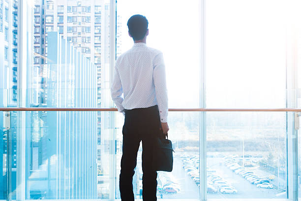 istock Businessman looking out of the window 502046856