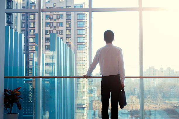 istock Businessman looking out of the window 502047068