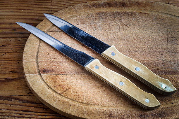 istock knives and cutting board on wooden background 502049890